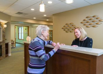 attentive otterbein staff member greets a cridersville senior living resident