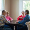 franklin otterbein residents play cards in an independent living apartment