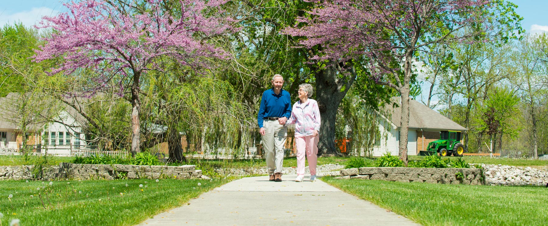 happy senior couple walking outside in the spring at otterbein