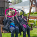 Resident and nurse sitting on swing smiling