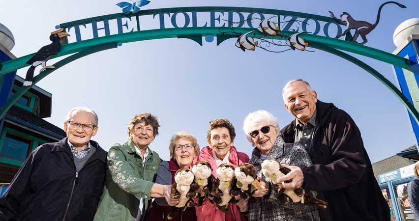 A group under the Toledo Zoo sign