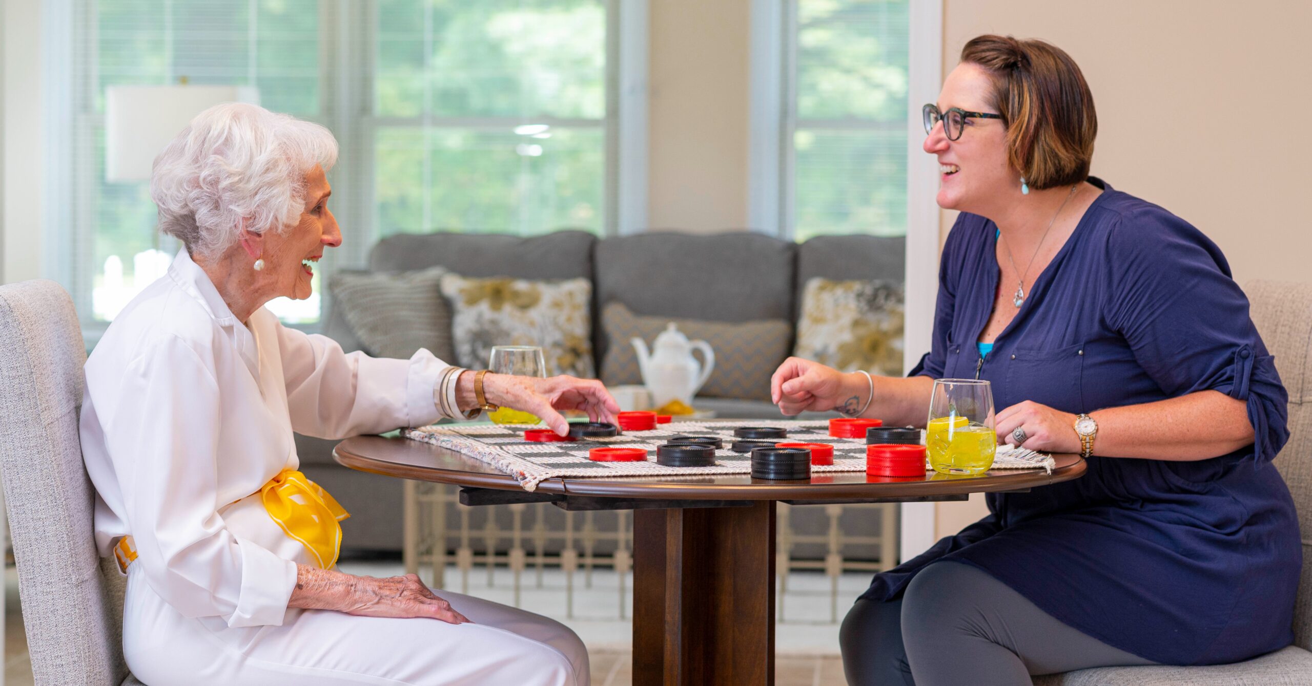 Otterbein resident playing checkers with an Otterbein staff member.