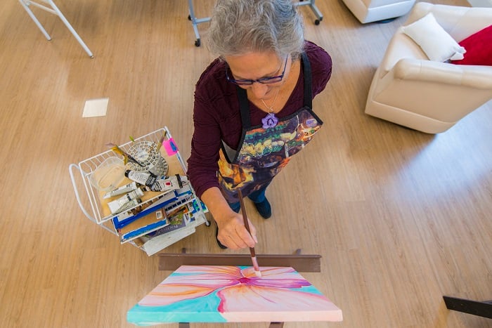 Woman at Otterbein SeniorLife paints on a canvas