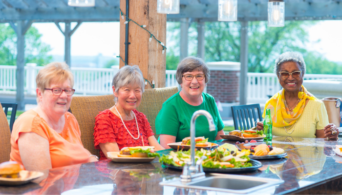 Group of women sit on sun-shaded terrace at Otterbein SeniorLife in Lebanon, Ohio