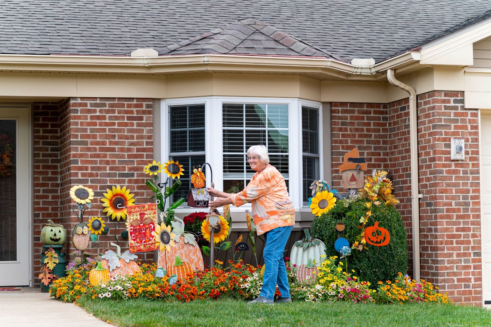 Otterbein resident shows off fall garden arrangement in front of her home