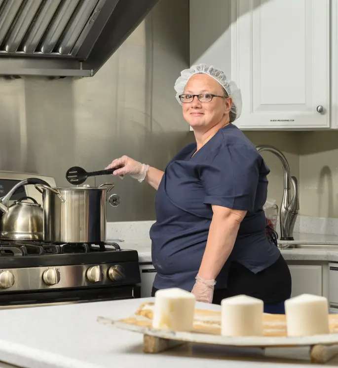 Otterbein small house elder cooking in the kitchen