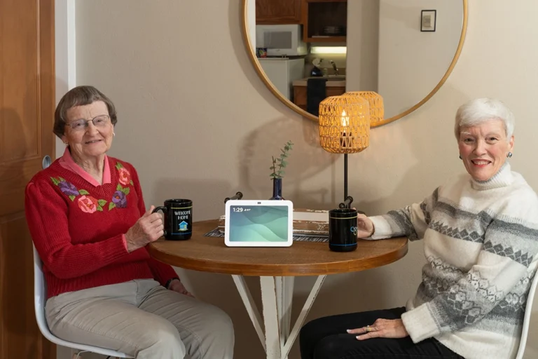 Two residents enjoying coffee and conversation at a cozy dining table at Otterbein Franklin.