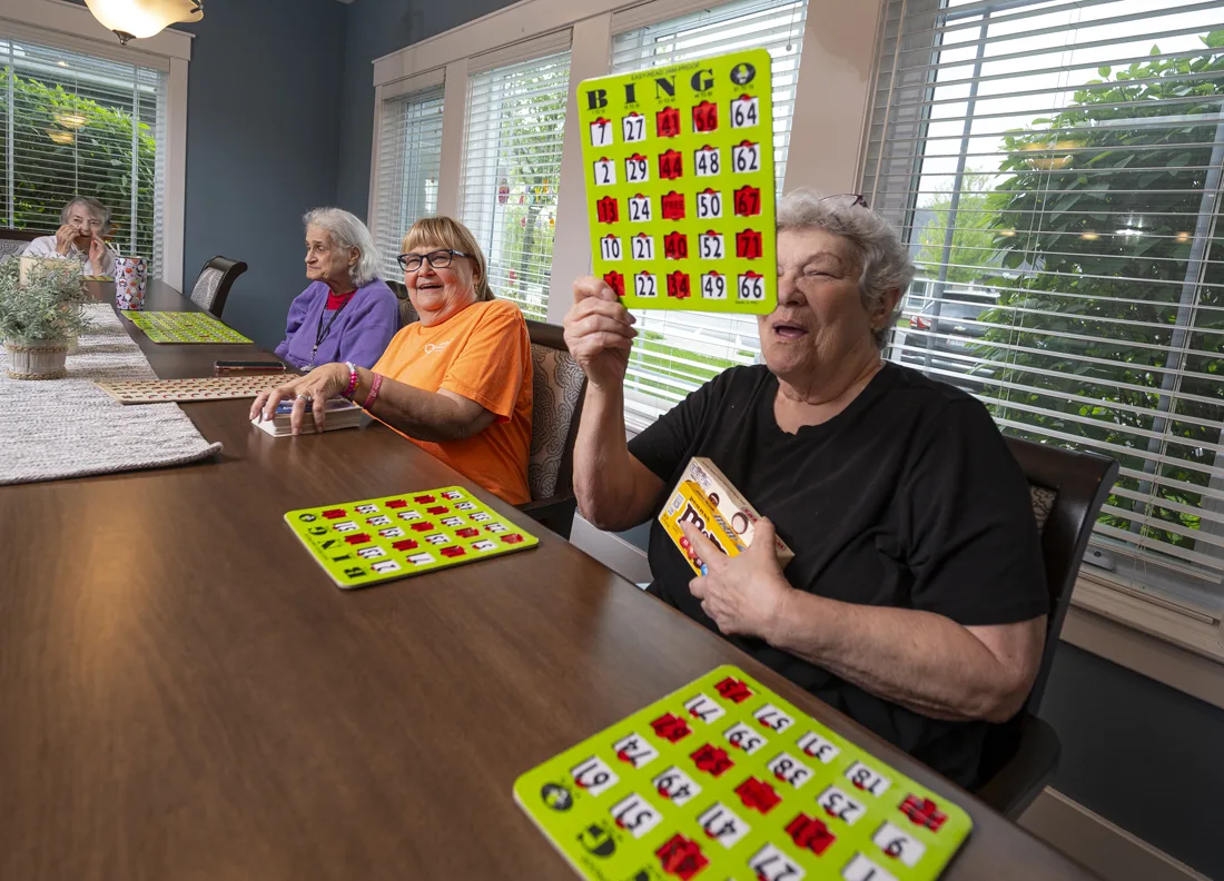 Otterbein small house elders play bingo at a large table