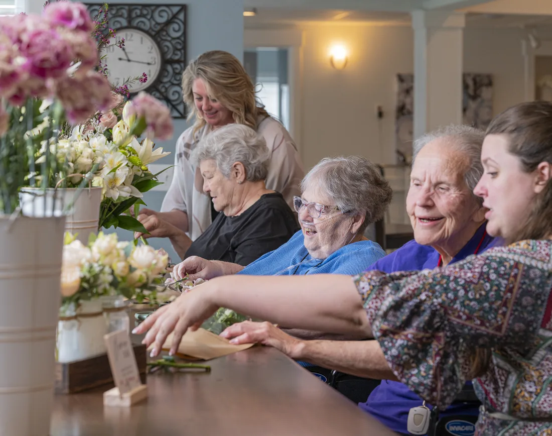 Otterbein elder assistant and small house elders arrange fresh flowers