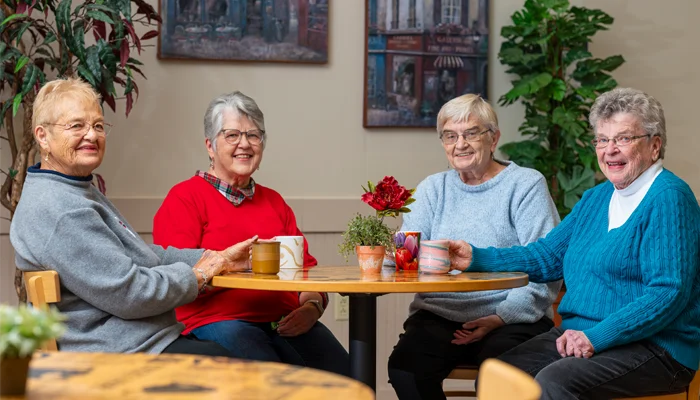 Otterbein residents enjoying drinks and conversation at a table