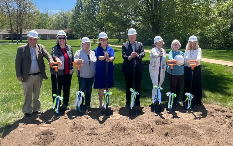 Otterbein Groundbreaking ceremony picturing residents wearing hardhats and holding shovels with ribbons