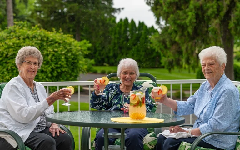 Otterbein Tipp City Residents sharing drinks outside on the patio