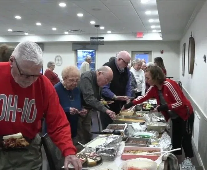 Otterbein residents select food from a Thanksgiving buffet