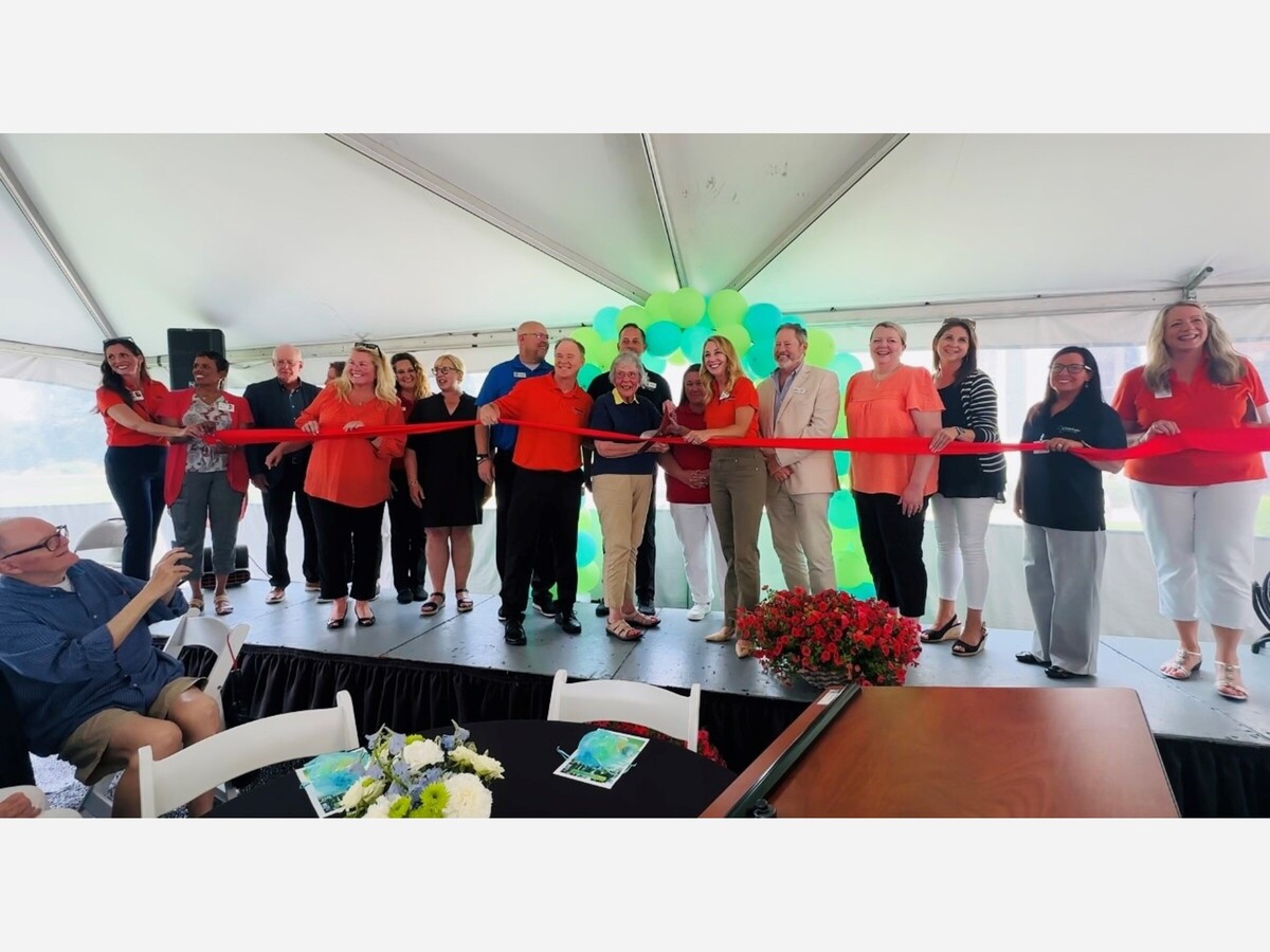 Otterbein Tipp City staff and residents hold ribbon for dedication and ribbon cutting ceremony