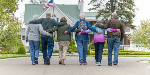 Otterbein residents walking toward the White House community center with their arms around each other