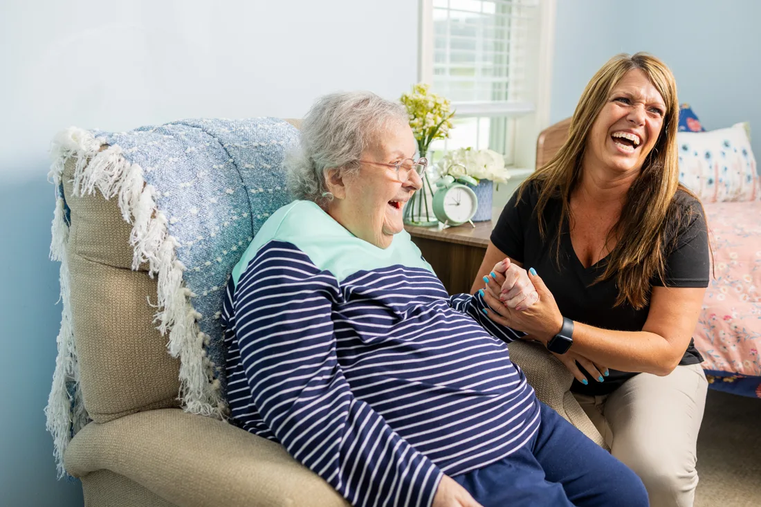 Otterbein Union Township elder holds hands with a partner as they smile and laugh