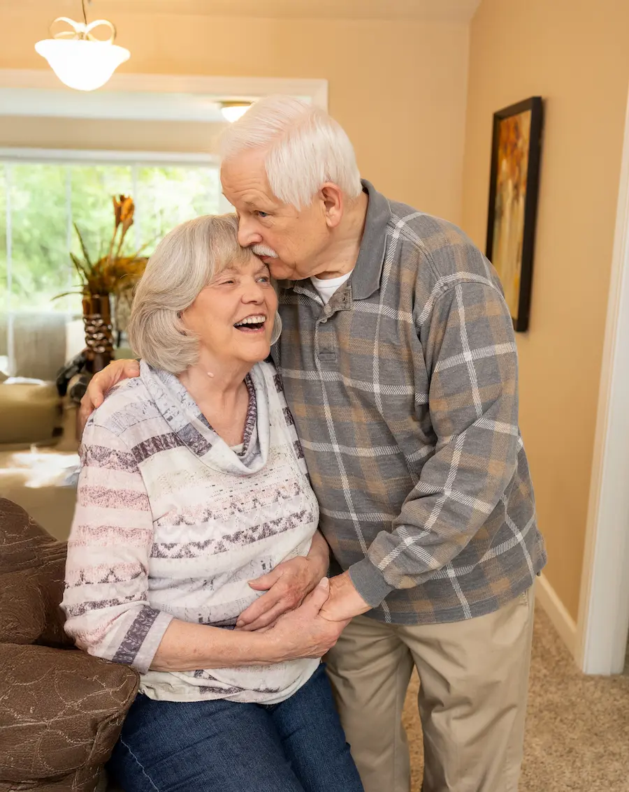 Otterbein Marblehead resident couple embraces in a living area