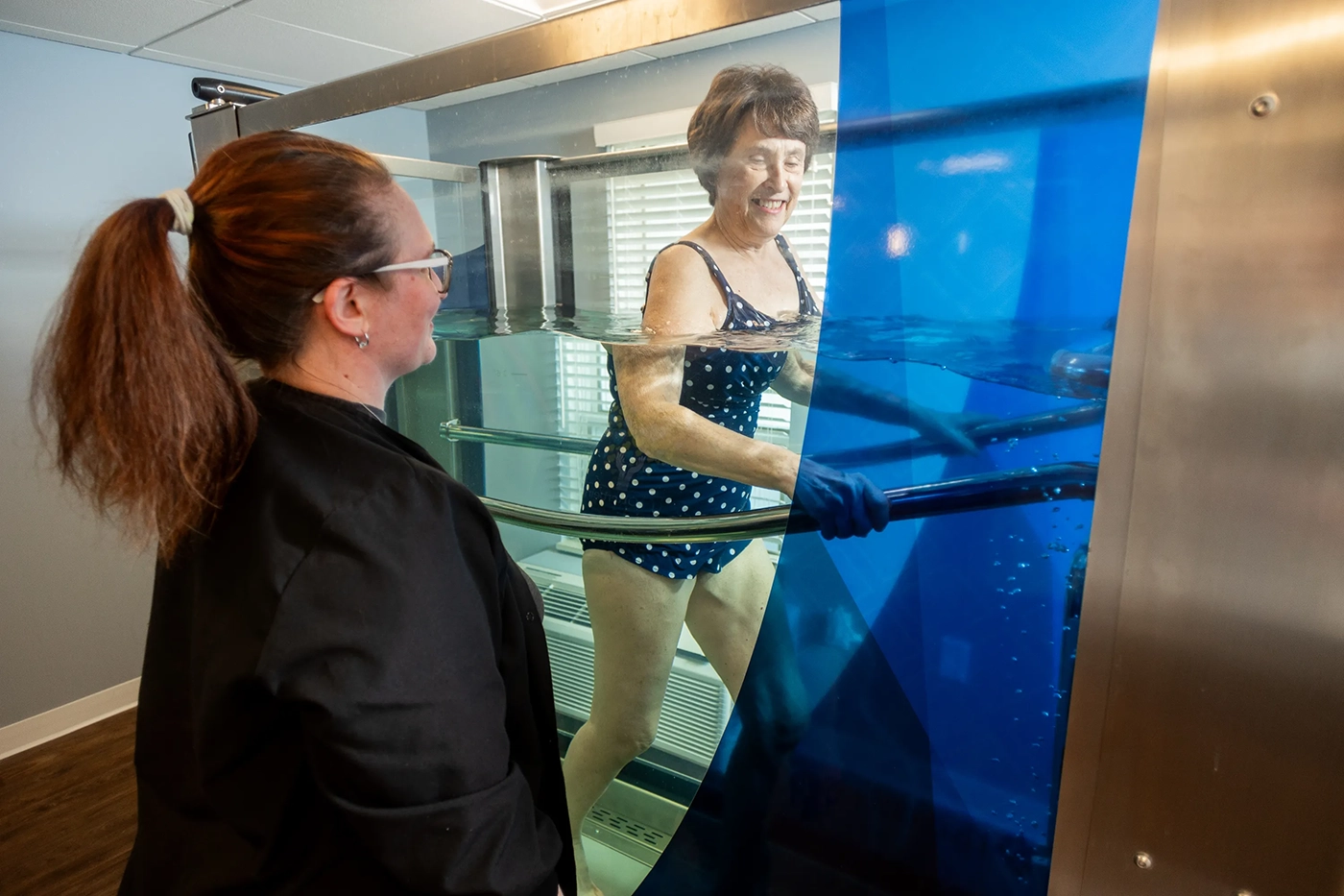 Otterbein Pemberville resident exercising using water therapy with a therapist standing by