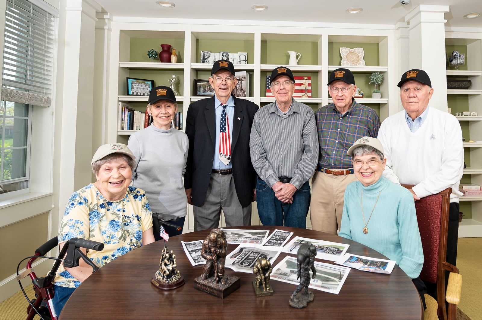 Otterbein resident Veterans standing together wearing Veteran hats