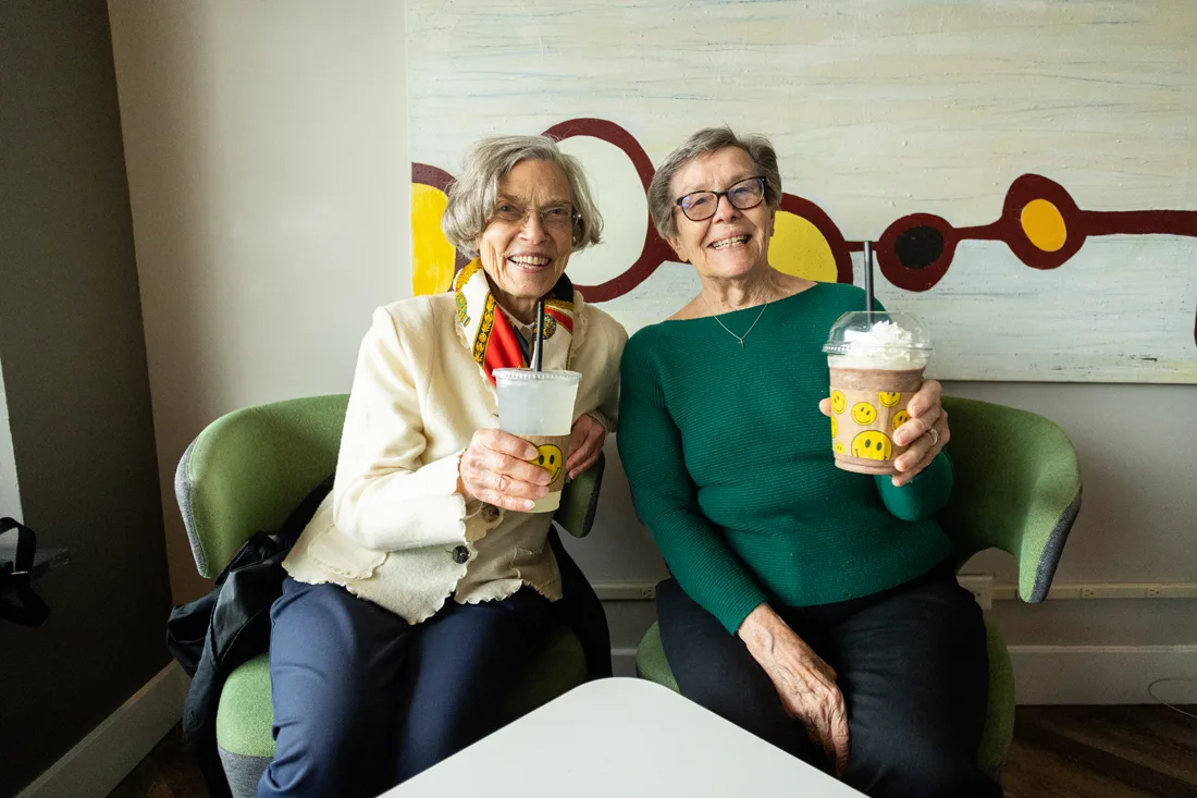 Female residents share drinks and smiles together on an outing with Otterbein Sunset House