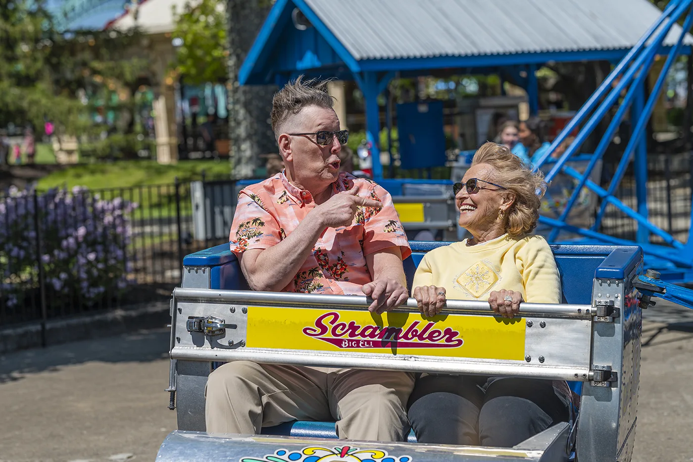 Male and female residents ride the Scrambler at Kings Island together on a resident bus outing