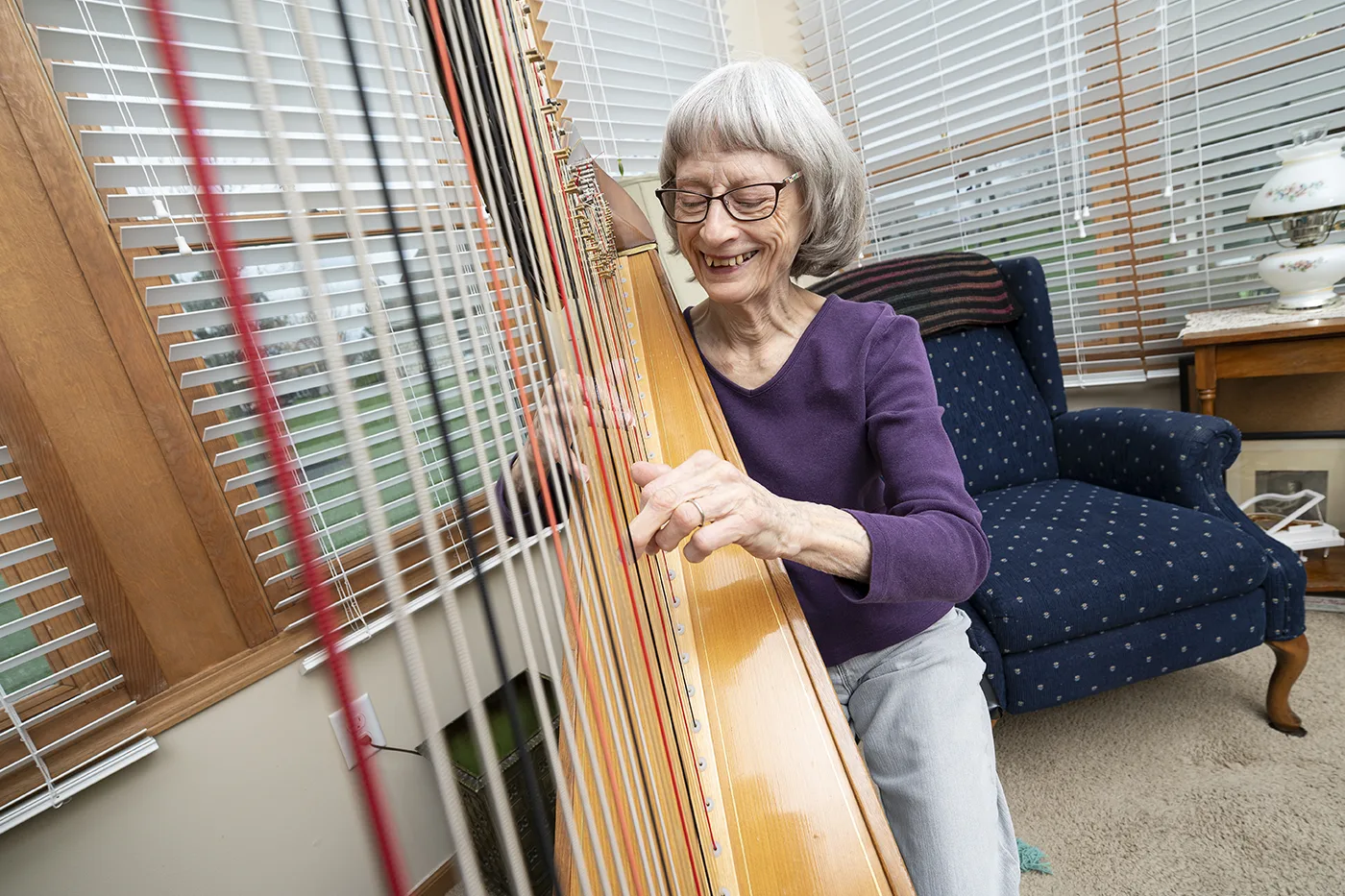 Female resident plays her harp