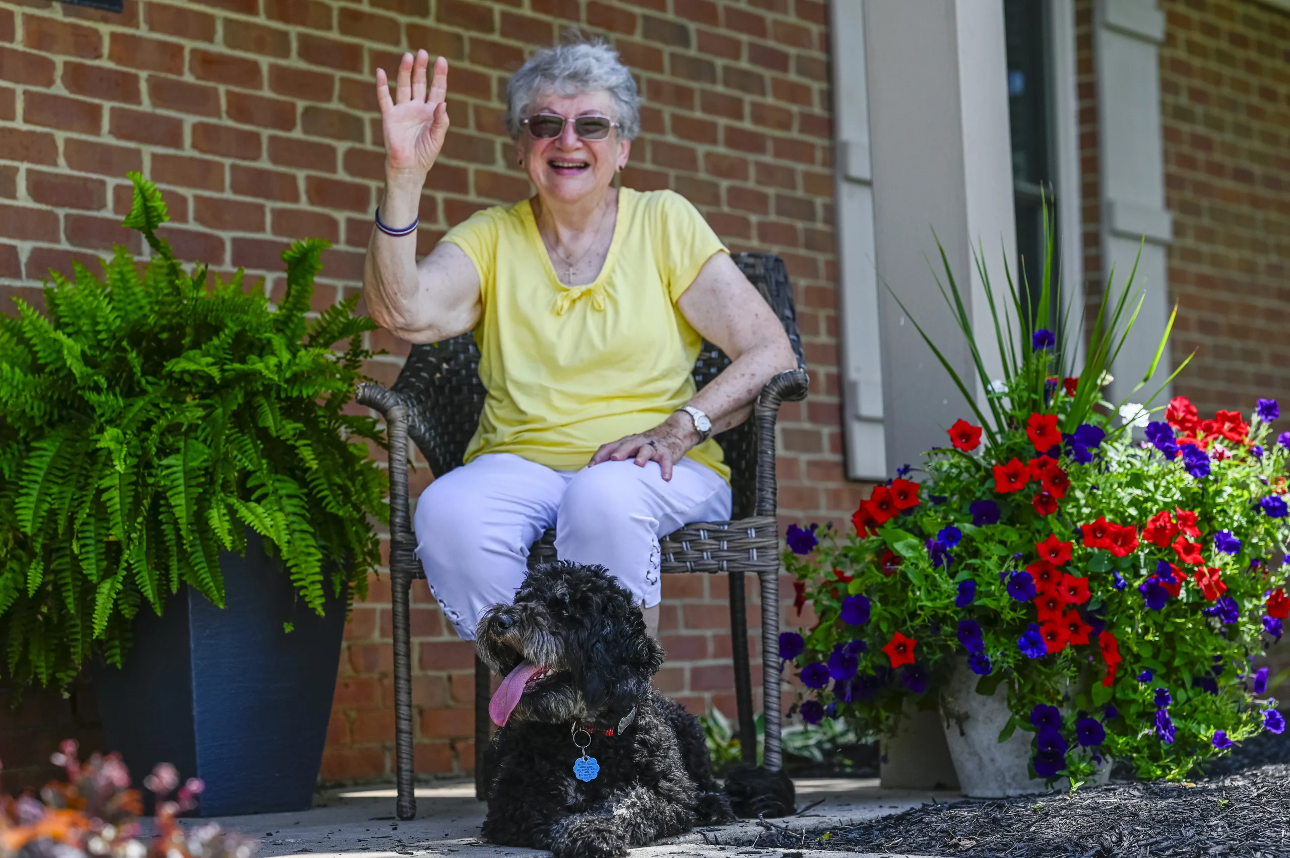 Woman Smiling and Waving with Dog